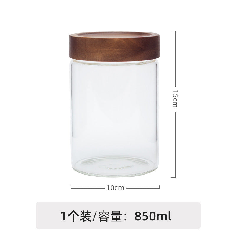 Whole freeze-dried dark red rose crown tea blossom unfurling inside an architectural borosilicate glass ritual jar