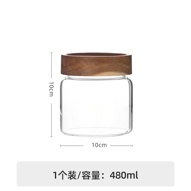 Whole freeze-dried dark red rose crown tea blossom unfurling inside an architectural borosilicate glass ritual jar